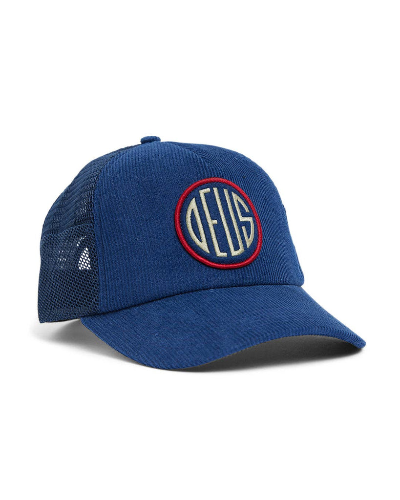 Blue corduroy and mesh baseball cap with red-outlined DEUS circular logo embroidery on the front.