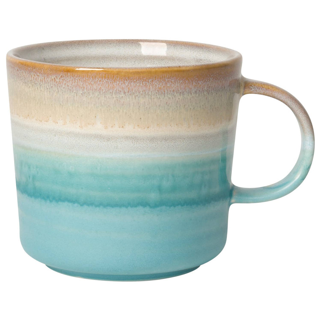 Ceramic mug with an ombre design in earthy brown and aqua tones, featuring a round handle.
