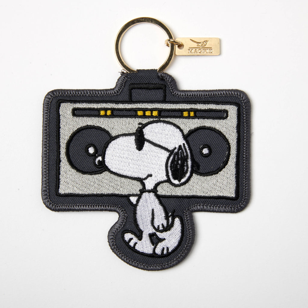 Embroidered keychain with a classic boombox design and a relaxed character wearing sunglasses, attached to a gold keyring.