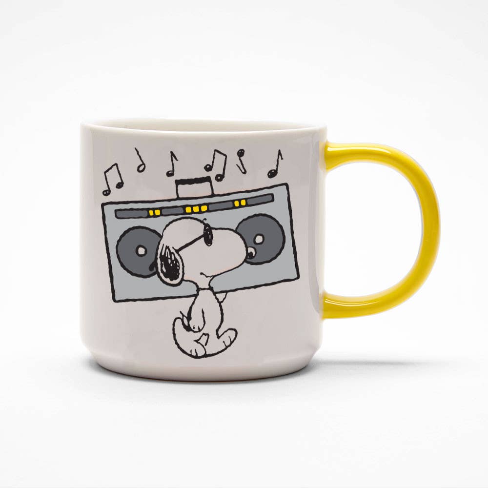 Ceramic mug featuring Snoopy with a boombox and musical notes, paired with a cheerful yellow handle.