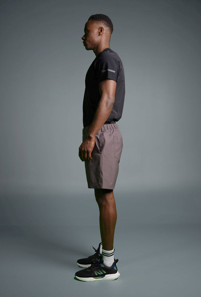 Man wearing Voyager Shorts and a light blue t-shirt, showcasing a comfortable and stylish casual look.