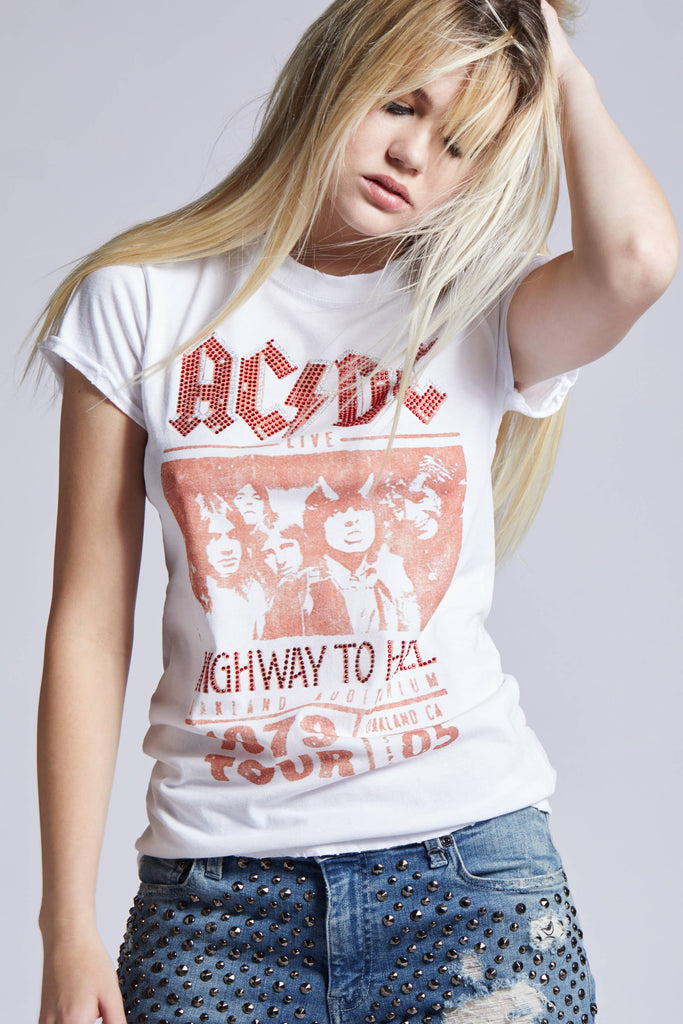 Young woman wearing an AC/DC "Highway to Hell" graphic t-shirt paired with studded denim shorts, exuding a cool, rock-inspired vibe.