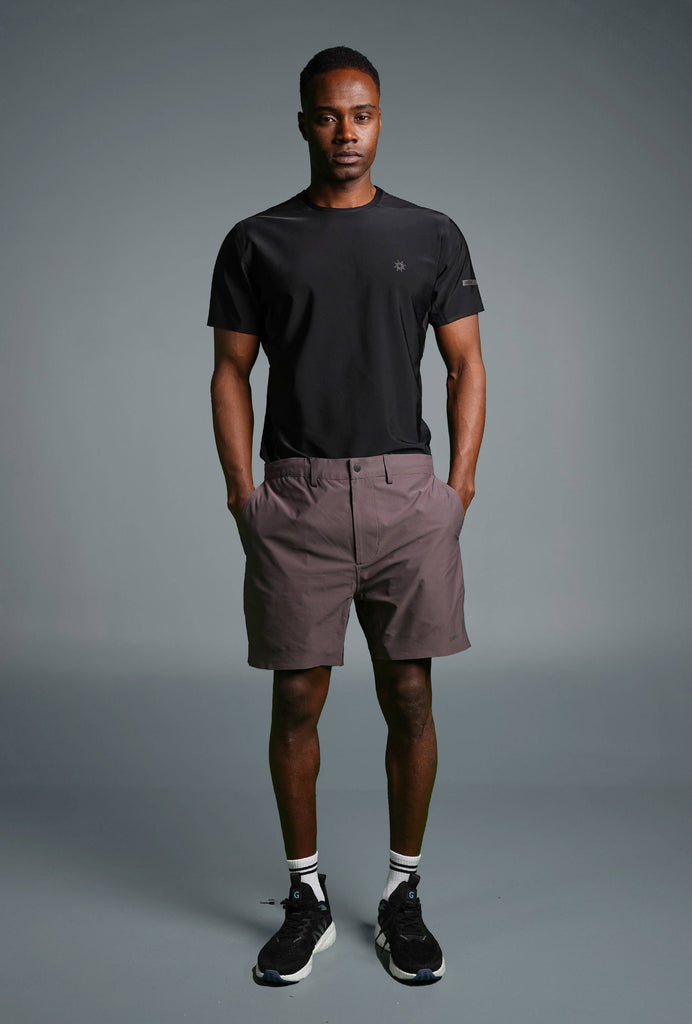 Man wearing Voyager Shorts and a light blue t-shirt, showcasing a comfortable and stylish casual look.