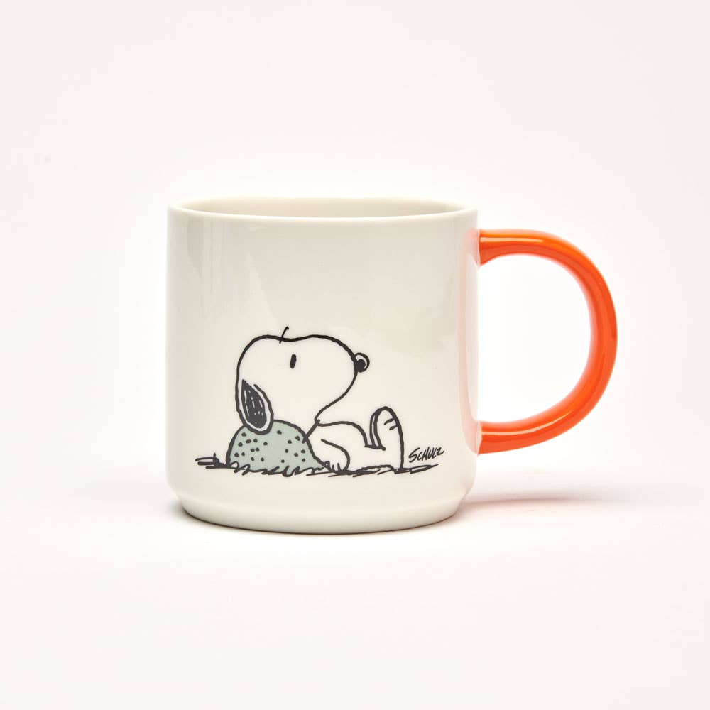 Ceramic mug featuring Snoopy lying down in a relaxed pose, paired with a vibrant orange handle.