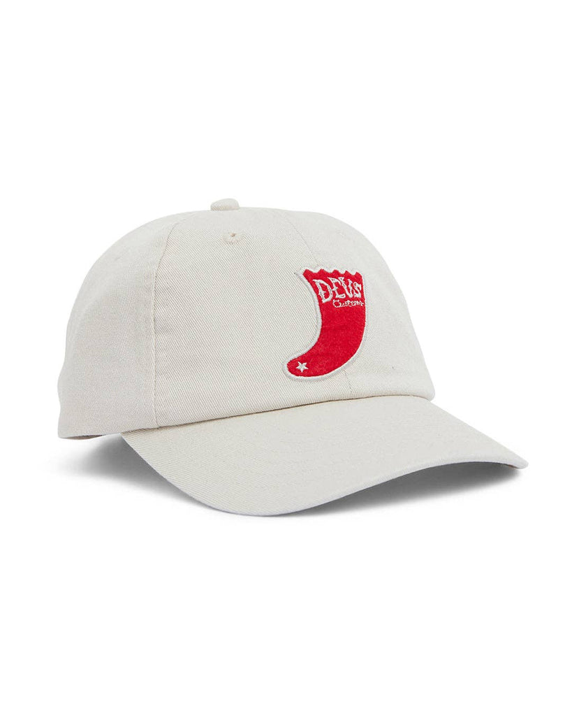 Ivory baseball cap with a red embroidered “DEUS Customs” patch on the front