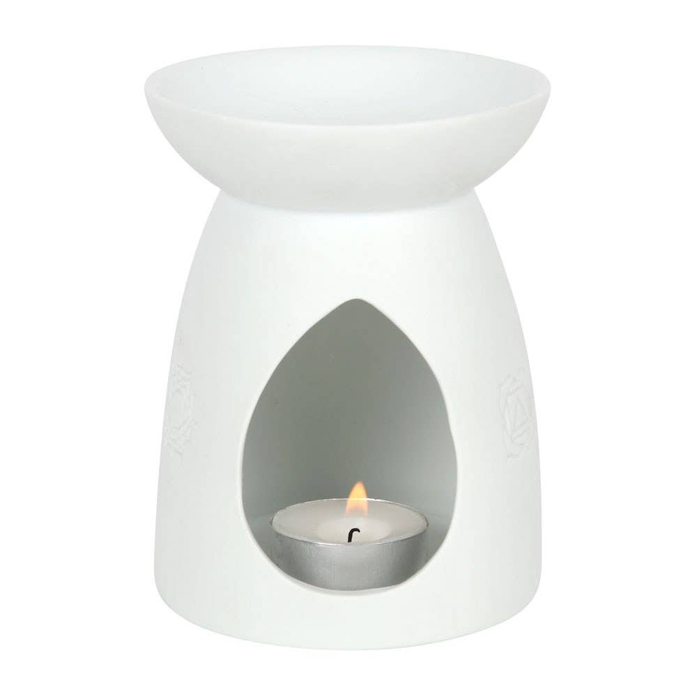 White stoneware essential oil burner with engraved moon phase design.