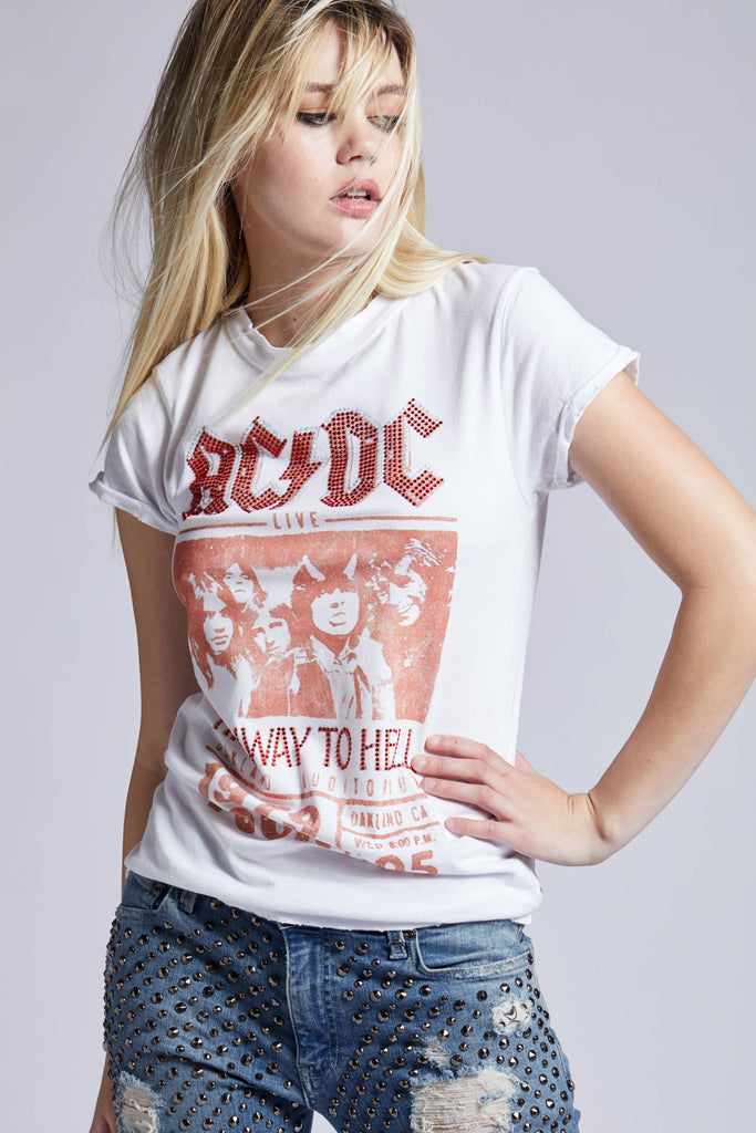 Young woman wearing an AC/DC "Highway to Hell" graphic t-shirt paired with studded denim shorts, exuding a cool, rock-inspired vibe.