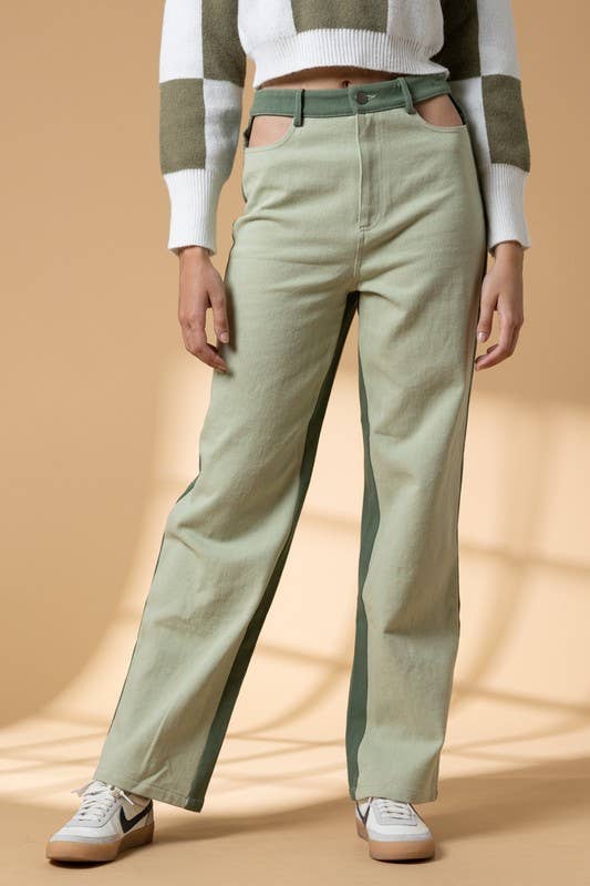 Woman wearing high waist color block pants with cutout details.
