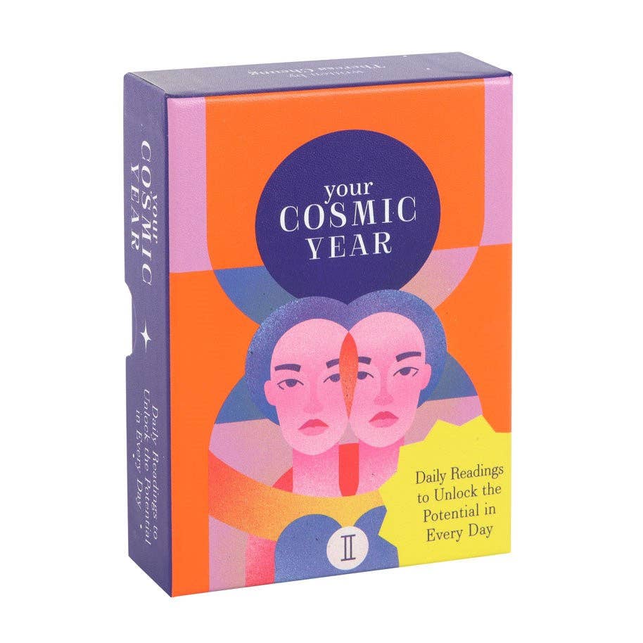 Your Cosmic Year astrology deck in bold orange, pink, and purple packaging with illustrated mirrored faces and celestial elements.