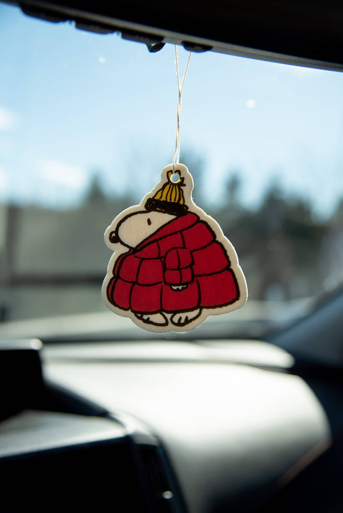 Peanuts® Snoopy Puffy Coat Air Freshener with pine forest scent, featuring Snoopy in a red puffy coat and yellow hat.