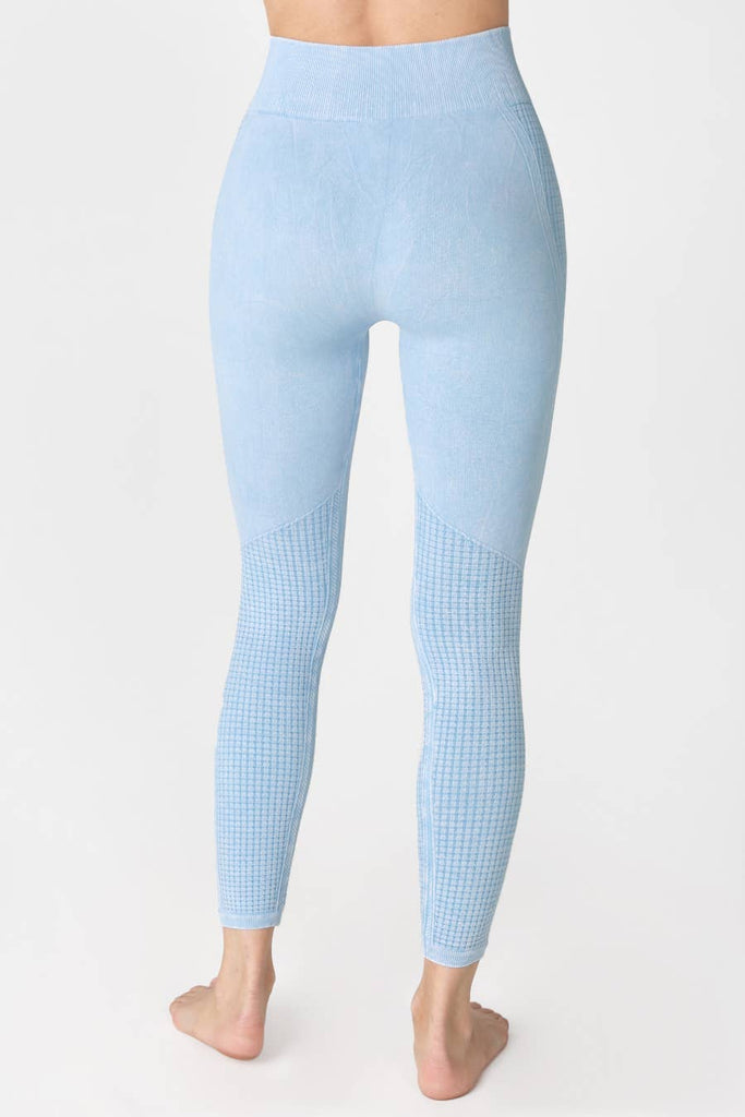 Woman wearing Harmony High-Waist Ribbed Leggings in light blue, featuring a high-rise fit and ribbed texture, perfect for workouts or casual wear.