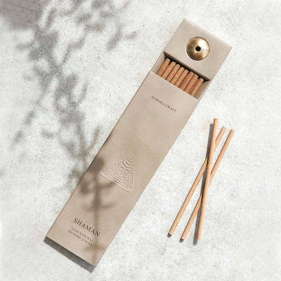 Shaman natural incense sticks in a taupe box with an embossed tribal symbol and built-in holder for grounding and spiritual balance.