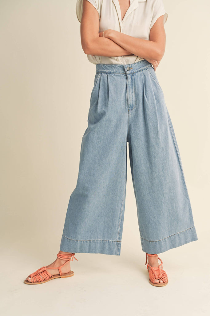 Model in wide-leg denim crop pants.