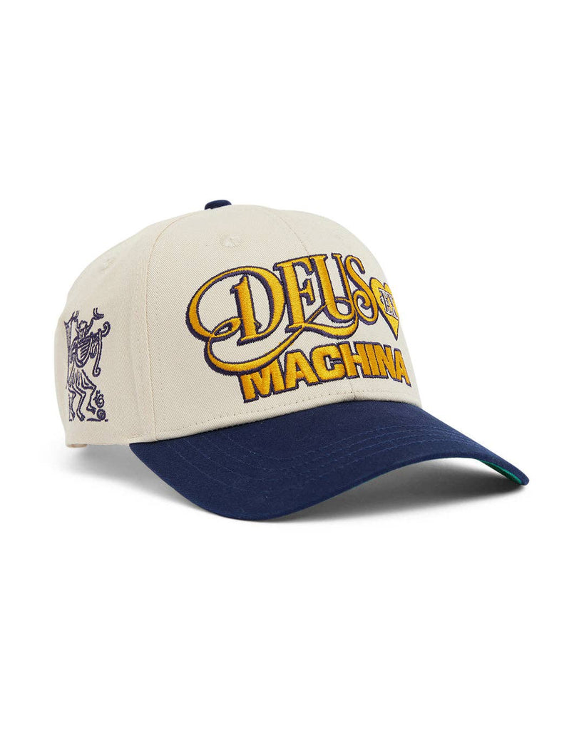 Ivory and navy DEUS Machina cap with yellow embroidered logo and side graphic