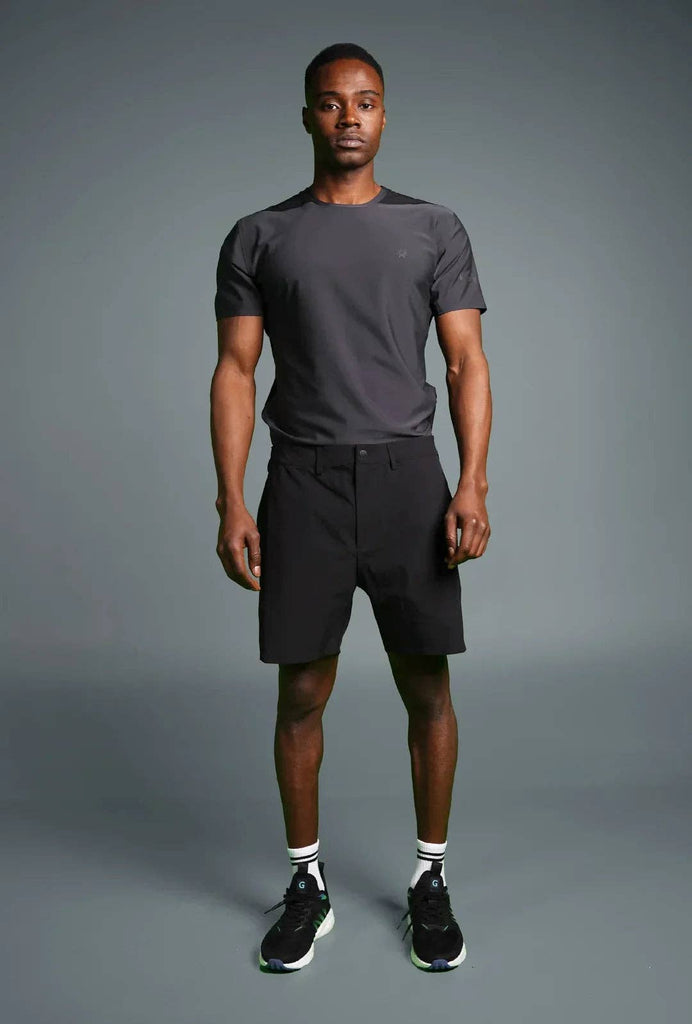 Man wearing Voyager Shorts and a light blue t-shirt, showcasing a comfortable and stylish casual look.