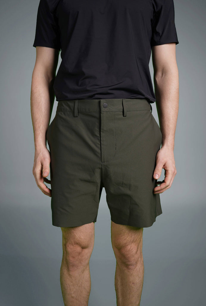 Man wearing Voyager Shorts and a light blue t-shirt, showcasing a comfortable and stylish casual look.