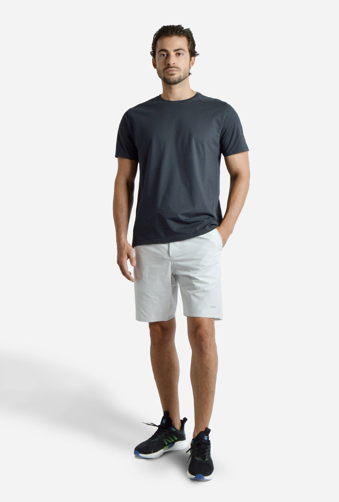 Man wearing Voyager Shorts and a light blue t-shirt, showcasing a comfortable and stylish casual look.