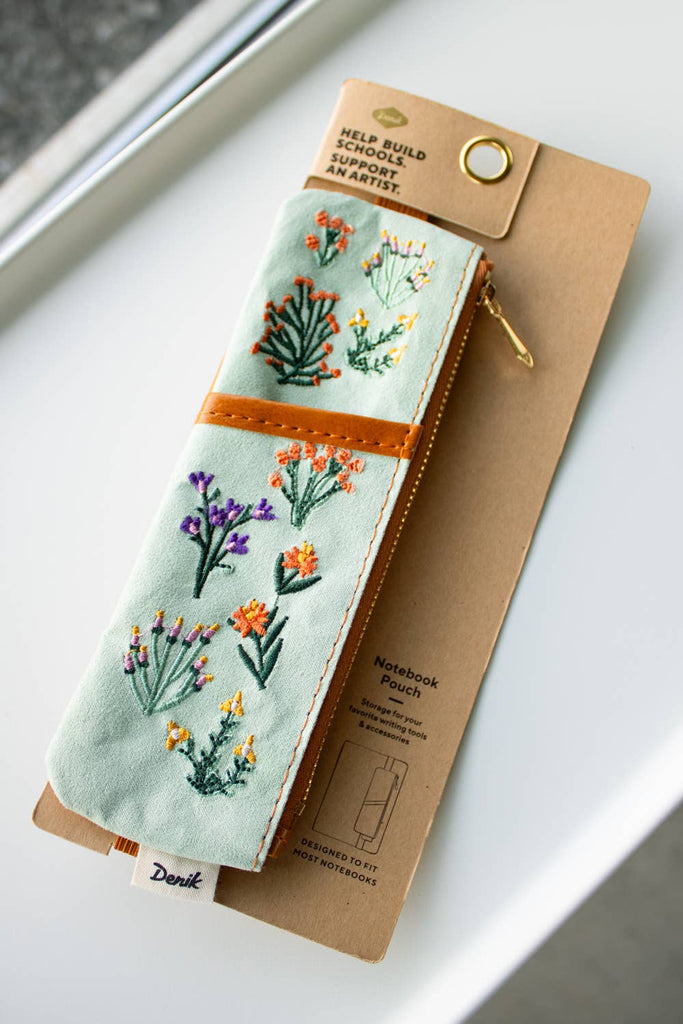 Petite Blooms embroidered pouch with floral designs on soft faux suede and an elastic band to fit most notebooks.