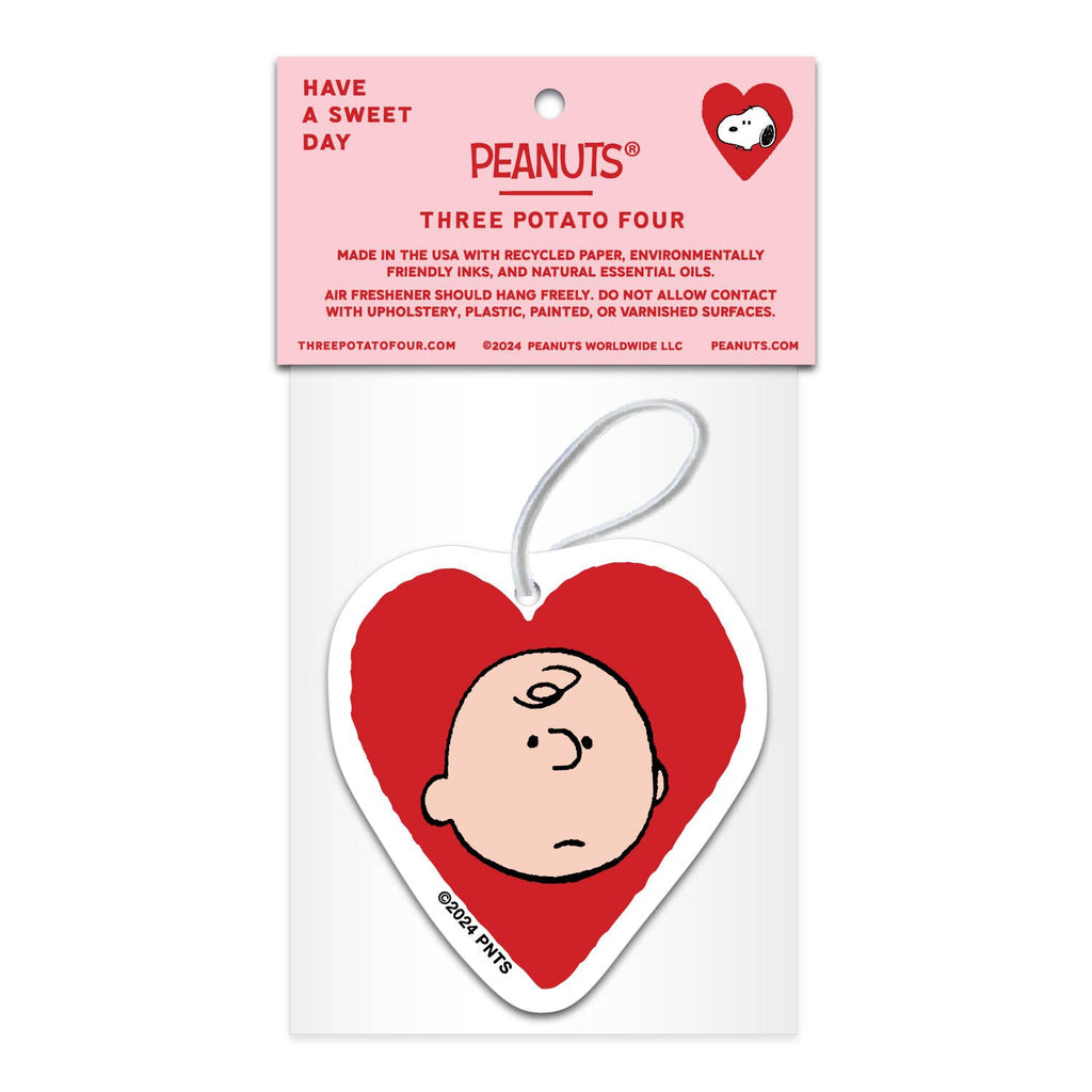 Peanuts® Valentine heart-shaped air freshener featuring Snoopy’s face in a red heart, infused with lavender scent, packaged with a pink and white card.