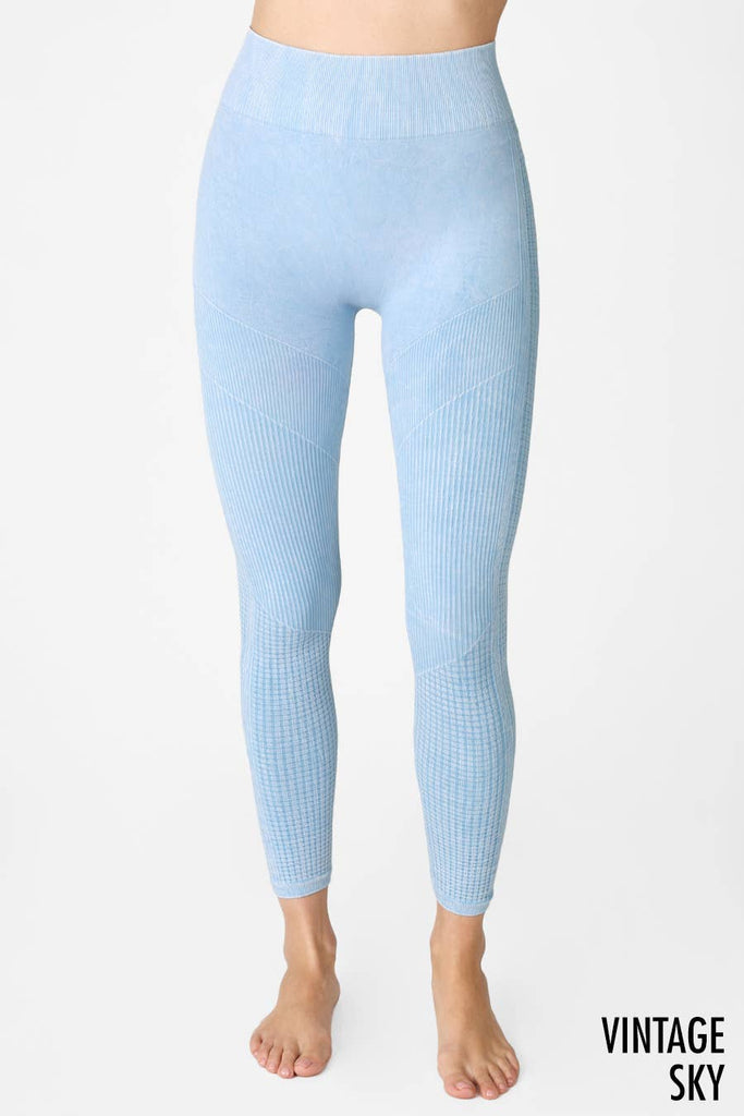 Woman wearing Harmony High-Waist Ribbed Leggings in light blue, featuring a high-rise fit and ribbed texture, perfect for workouts or casual wear.