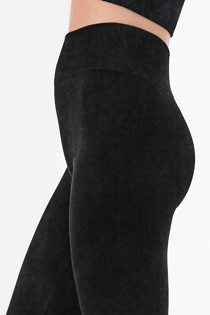 Woman wearing Serenity High-Waist Ribbed Leggings in vintage cool grey, featuring a high-rise waistband and ribbed texture for a sleek, supportive fit.