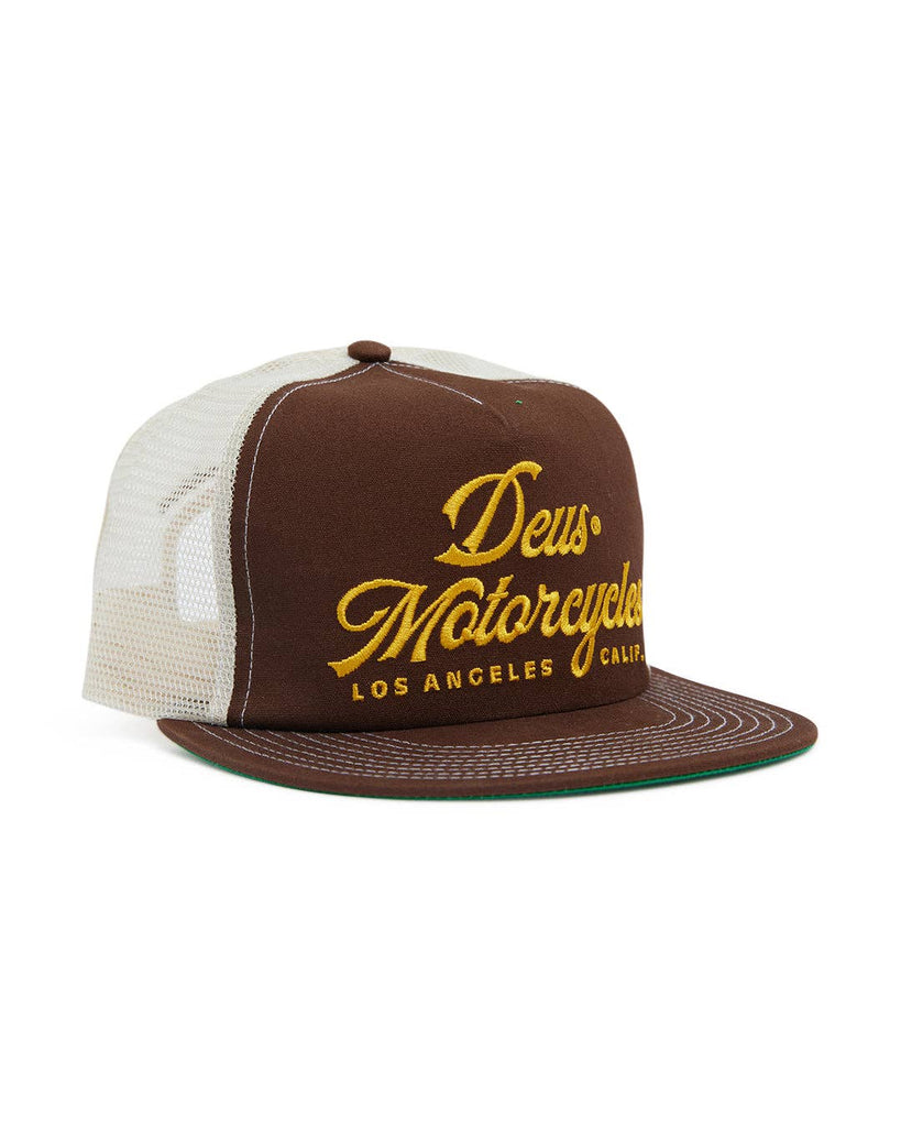 Brown trucker cap with yellow embroidered "Deus Motorcycles" script, mesh back, and adjustable fit.