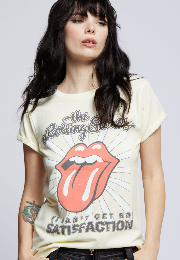 Woman wearing a vintage-style yellow Rolling Stones graphic t-shirt with the iconic tongue-and-lips logo and "Can't Get No Satisfaction" text.