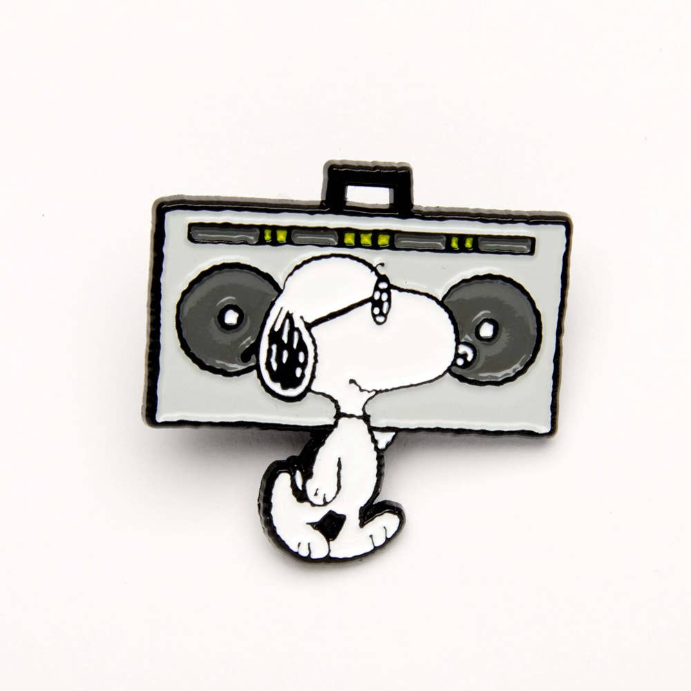 Enamel pin of Snoopy standing beside a boombox, listening to music.