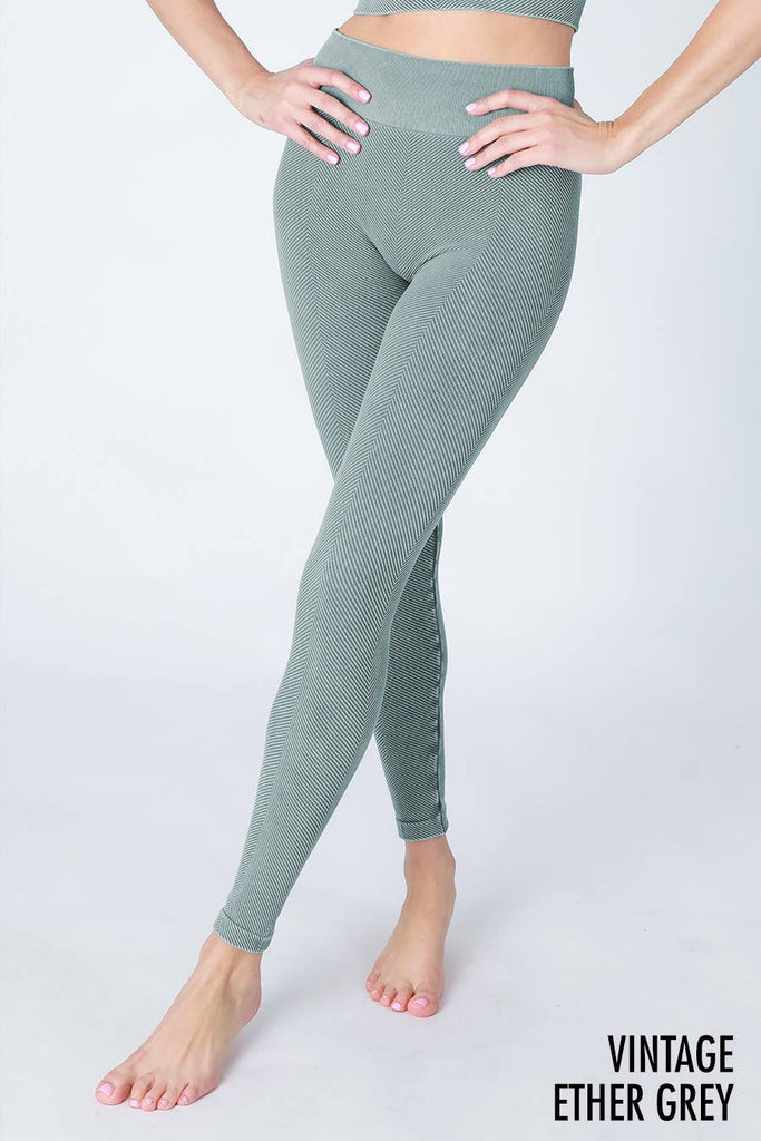 Woman wearing Serenity High-Waist Ribbed Leggings in vintage cool grey, featuring a high-rise waistband and ribbed texture for a sleek, supportive fit.