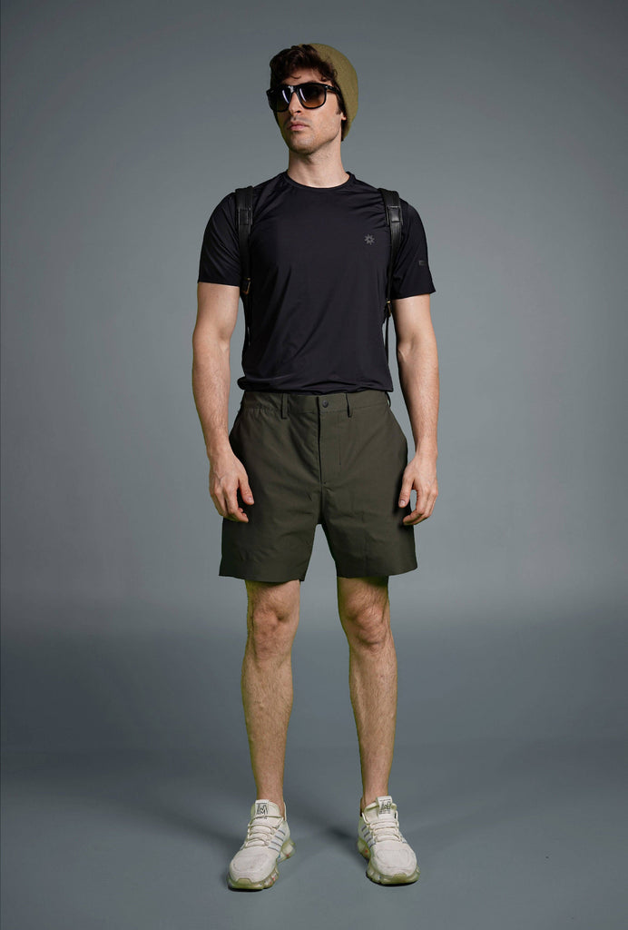 Man wearing Voyager Shorts and a light blue t-shirt, showcasing a comfortable and stylish casual look.