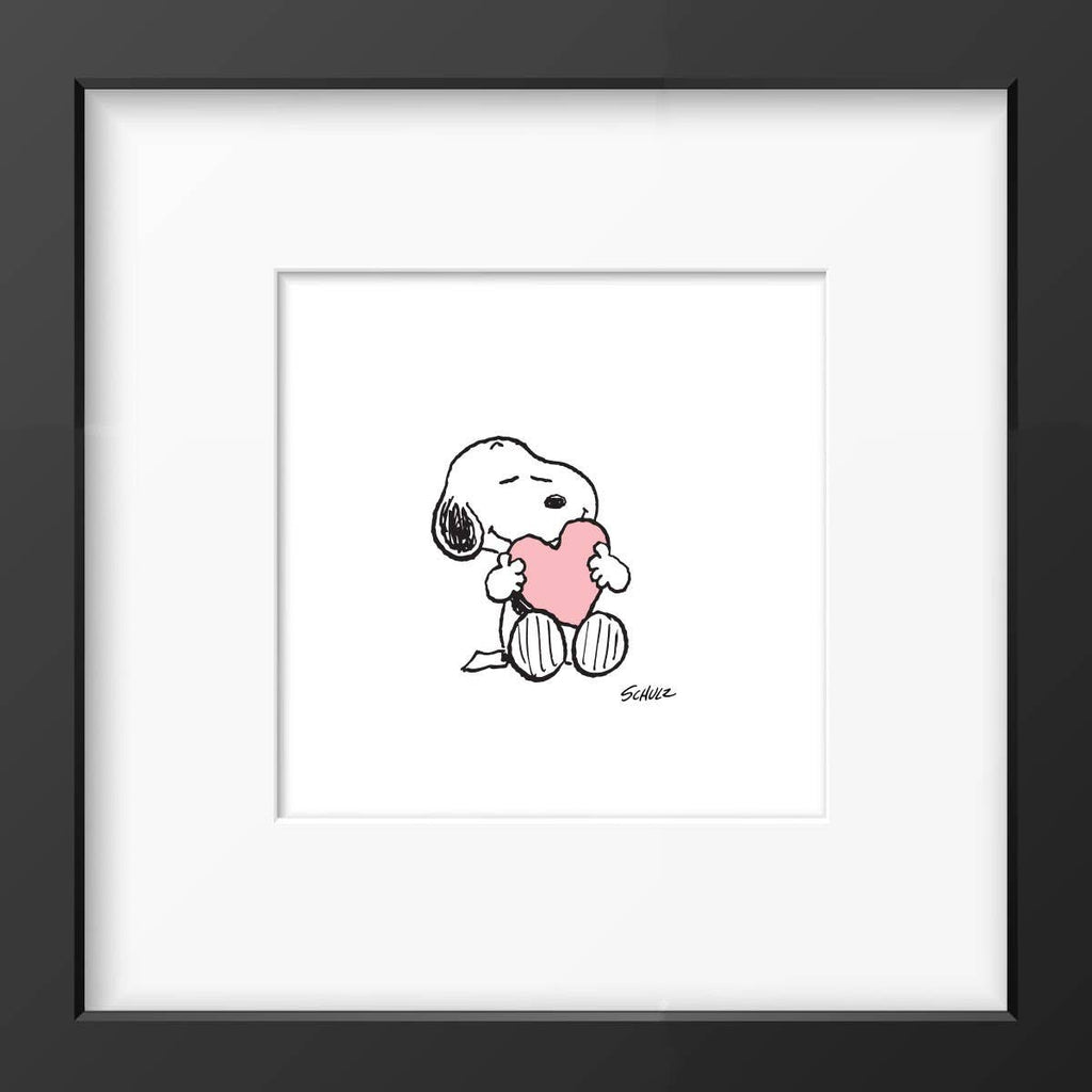 Framed artwork of Snoopy holding a pink heart, set against a white background with a simple black frame.