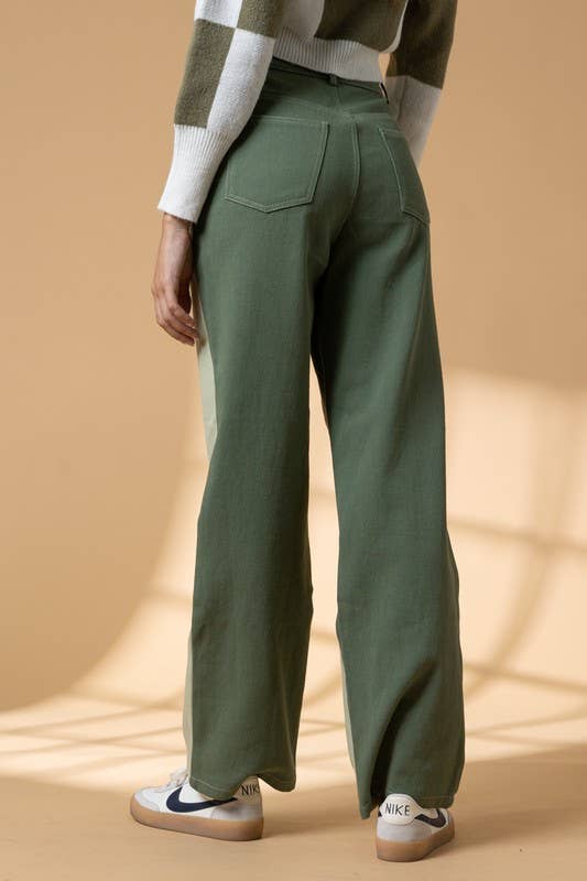 Woman wearing high waist color block pants with cutout details.