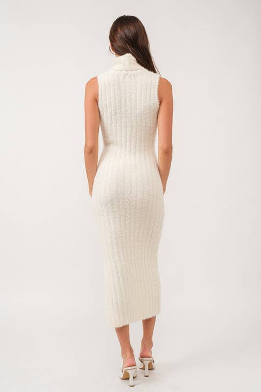 Woman wearing a sleeveless white turtle neck rib-knit midi dress.