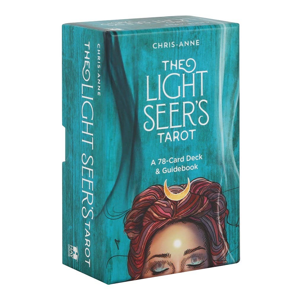 The Light Seer’s Tarot deck in teal packaging with illustration of a woman’s face, moon symbol, and swirling energy.