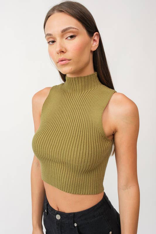 Woman wearing a cropped olive green mock neck ribbed knit sweater.