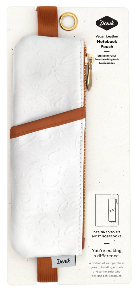 A white vegan leather notebook pouch with an embossed floral design, tan accents, and a gold zipper, attached to its packaging.