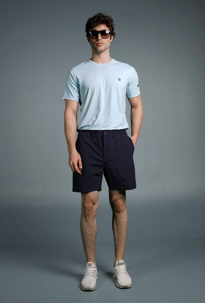 Man wearing Voyager Shorts and a light blue t-shirt, showcasing a comfortable and stylish casual look.