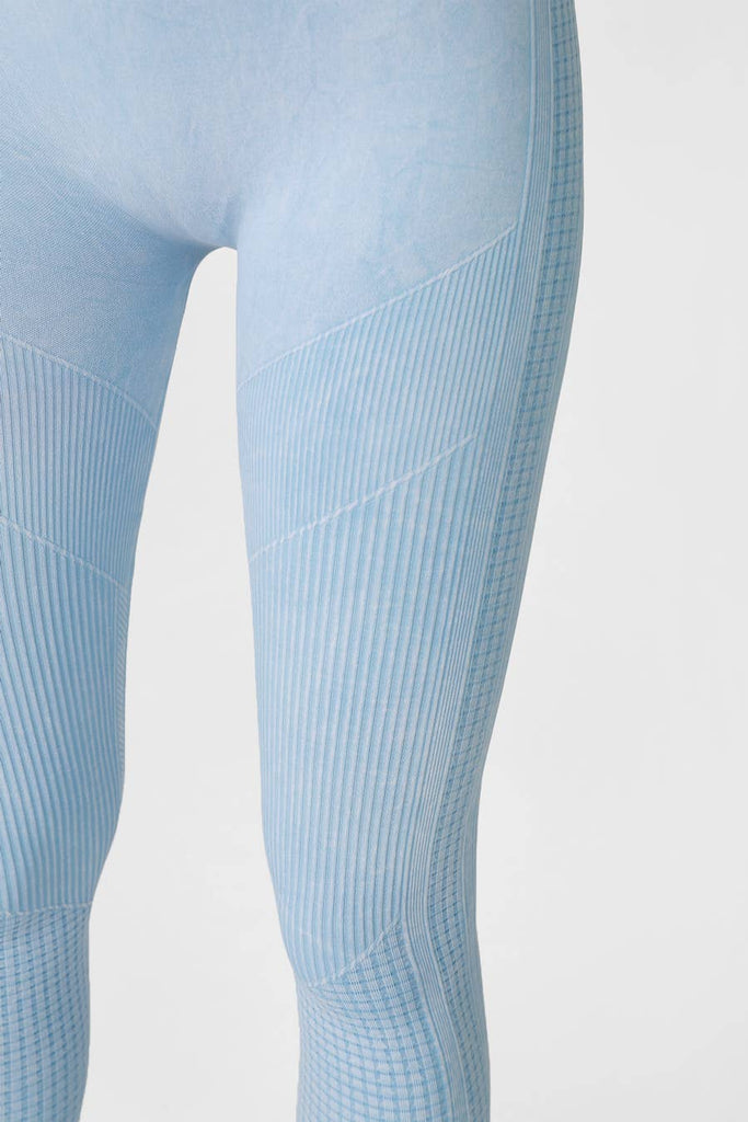 Woman wearing Harmony High-Waist Ribbed Leggings in light blue, featuring a high-rise fit and ribbed texture, perfect for workouts or casual wear.