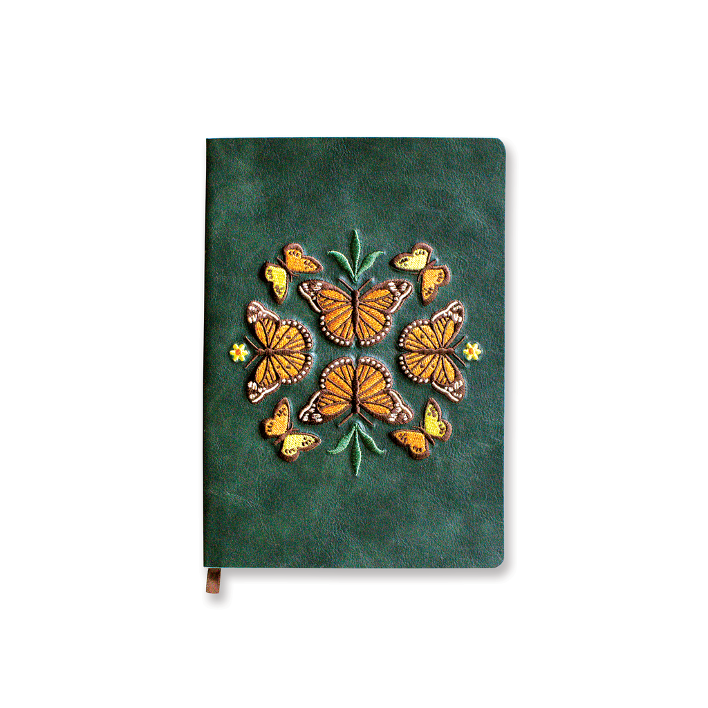 Green notebook with embroidered monarch butterfly design.