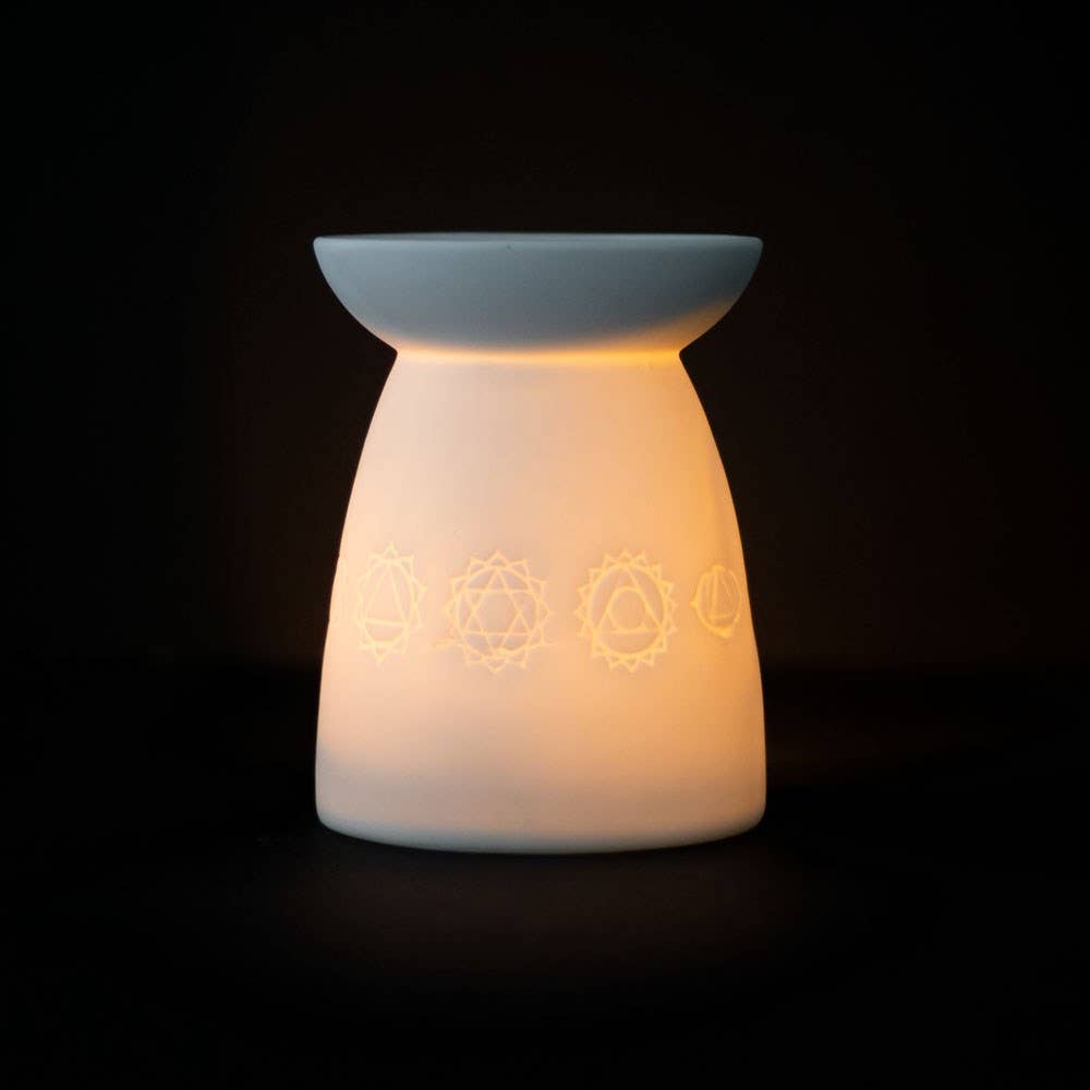 White stoneware essential oil burner with engraved moon phase design.