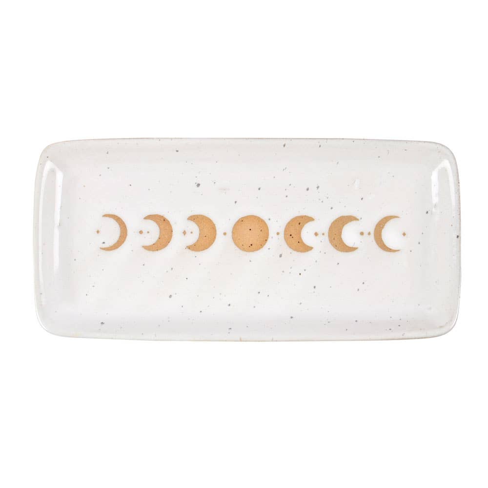 A beautiful stoneware trinket tray featuring a moon phase design with a wax resist finish, giving it a handmade feel.